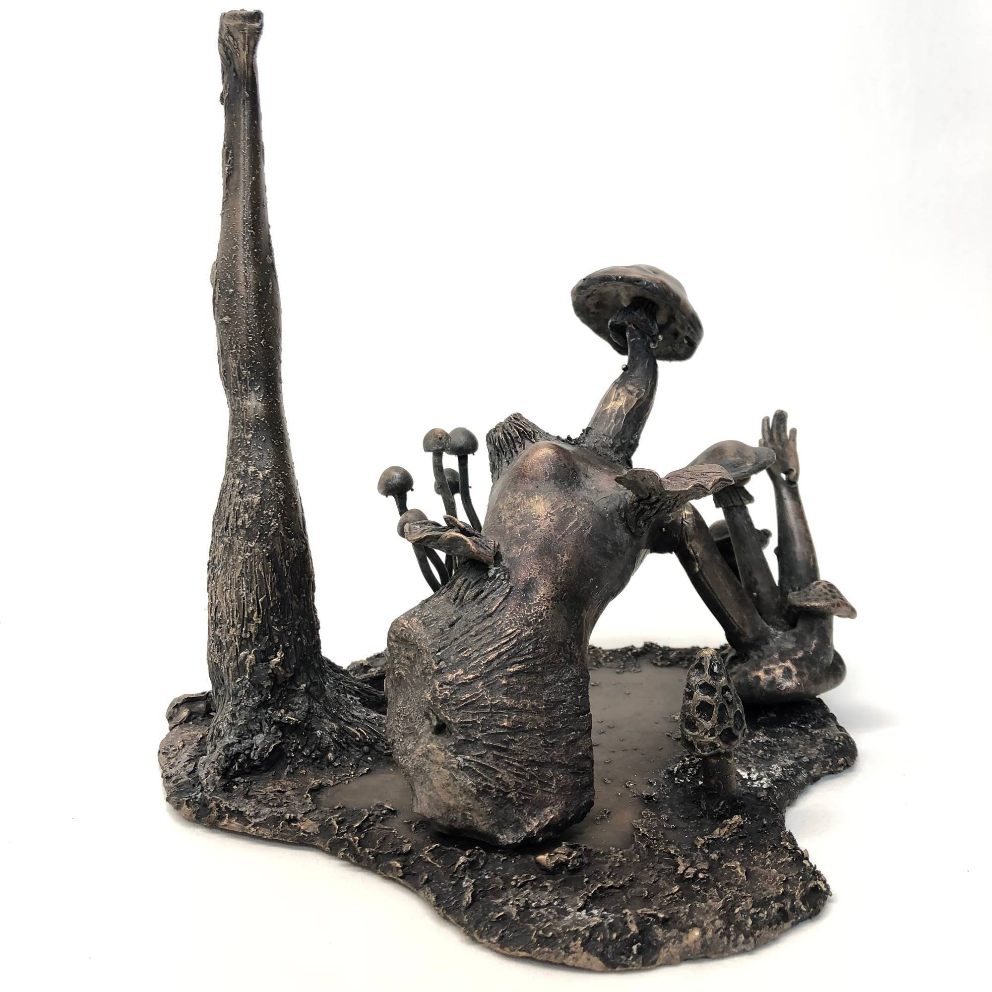 Sculpture that has a human-like figure rising from a marsh.